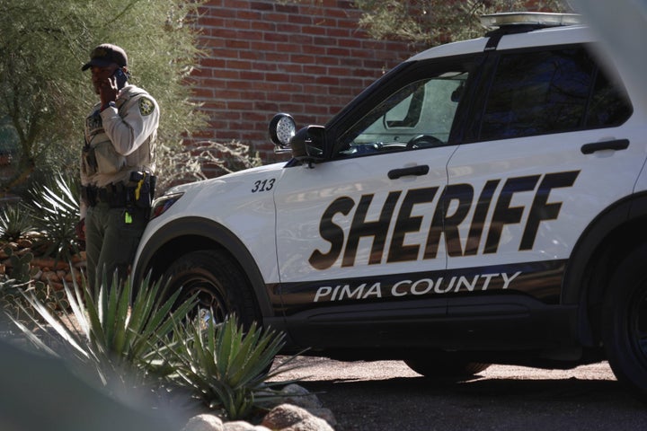 A Pima County sheriffs official stays outside of Nancy Guthrie‘s home on Saturday, Feb. 14, 2026 in Tucson, Arizona.