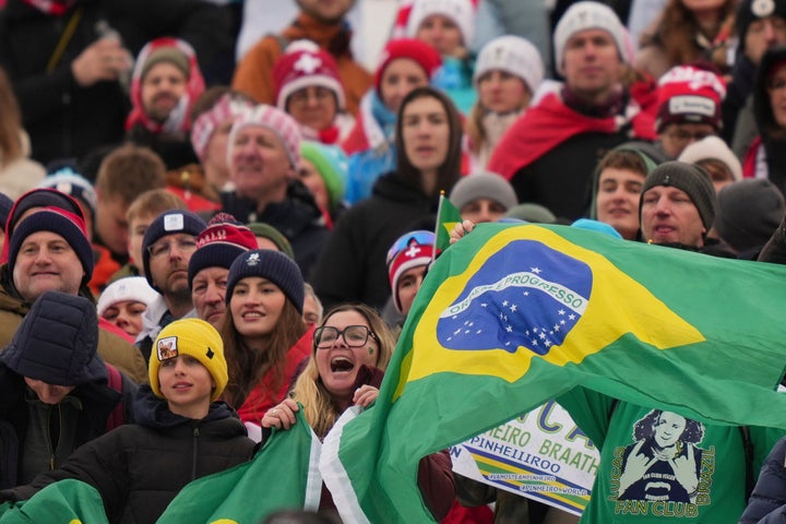 Brazilian fans cheer during the medal ceremony of a men's alpine skiing giant slalom race, won by Brazil's Lucas Pinheiro Braathen, at the 2026 Winter Olympics in Bormio, Italy, Saturday, Feb. 14, 2026. (AP Photo/Julia Demaree Nikhinson)