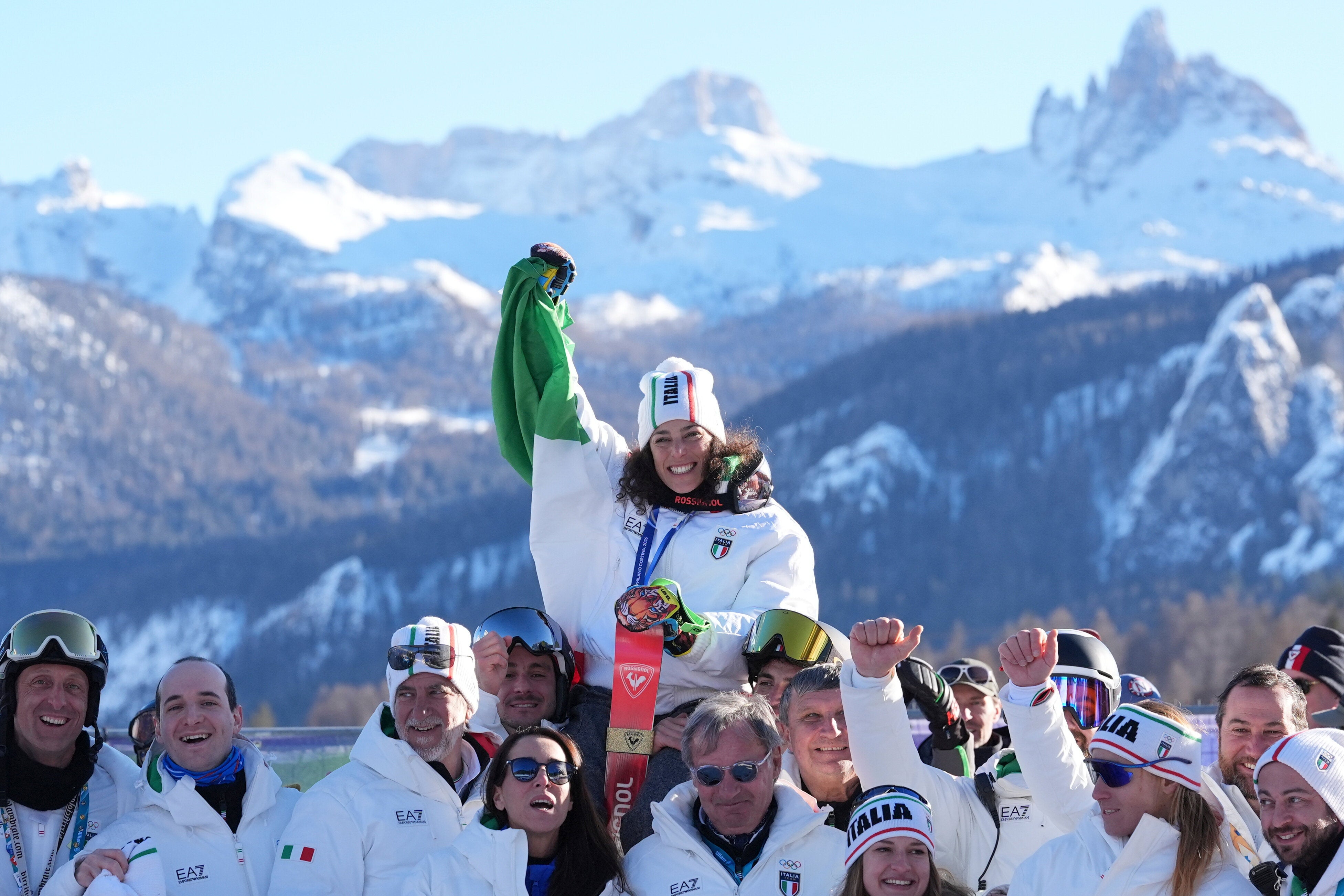 Italy's Federica Brignone (center) celebrates with the Italian athletes after winning the gold medal on Sunday.