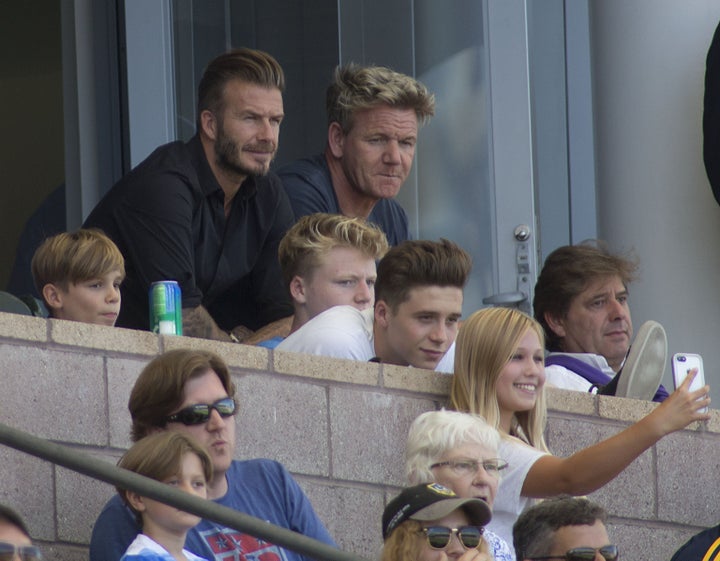 Sir David Beckham and Gordon Ramsay watching a football match with their sons in 2015