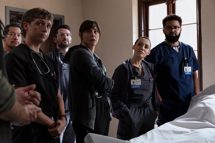 The team gathers to remember Louie, portrayed by Ernest Harden Jr.