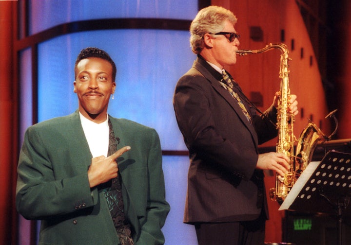 Then-Arkansas Governor Bill Clinton plays saxophone with the band during the musical inauguration of 