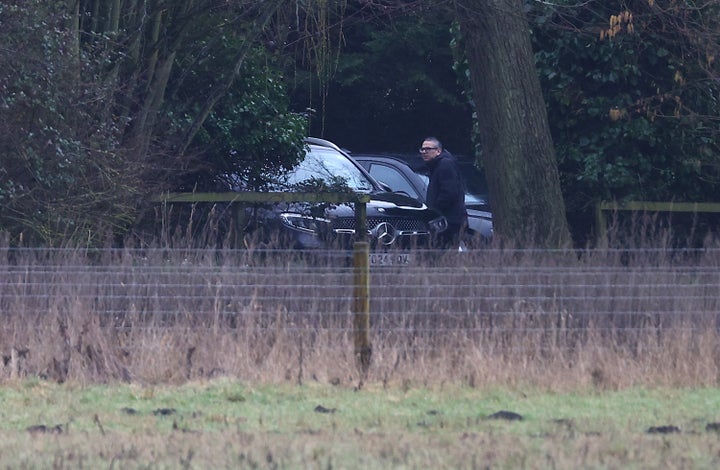 A man steps out of an unmarked car at the home of Andrew Mountbatten-Windsor on Thursday in Sandringham, Norfolk.