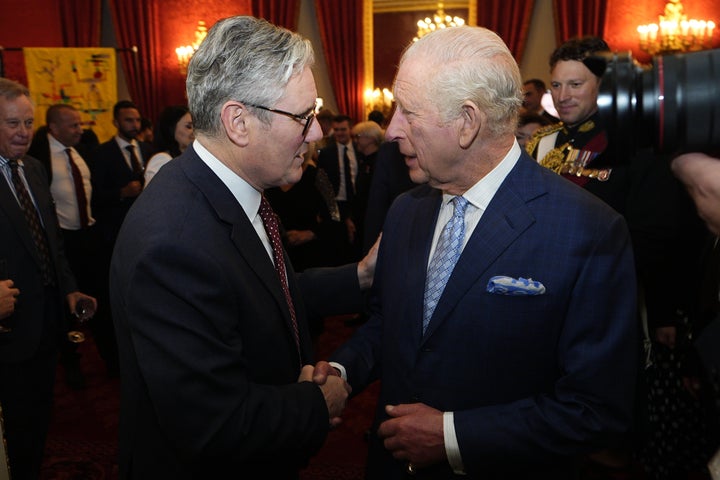 Britain's King Charles III speaks with Prime Minister Keir Starmer (left) as he departs a reception for Western Balkans leaders at St James's Palace in London on Oct. 21, 2025.