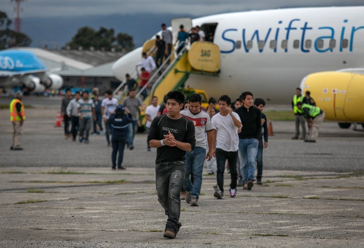 Men walk from a deportation flight in 2019 in Guatemala City, Guatemala.