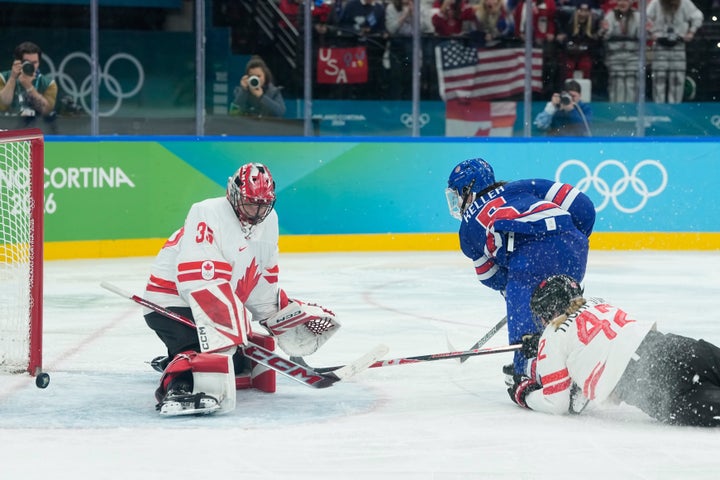 Team USA's Megan Keller (center) scores past Canada's Ann-Renee Desbiens (left) in the gold medal match against Canada in Milan on Thursday.