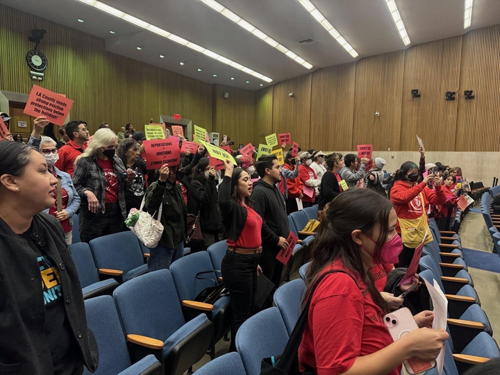 Community members at a February 3 Los Angeles Board of Supervisors meeting, holding signs in support of eviction protections.