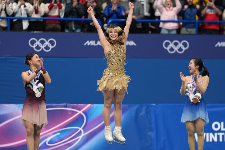Japan's Kaori Sakamoto (left) and Ami Nakai (right), who took silver and bronze respectively, cheered on gold medalist Alysa Liu as she jumped for joy after the women's free skate program on Thursday.