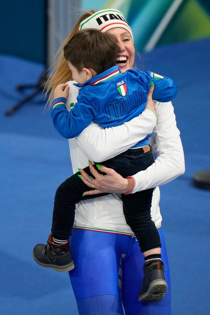 Italy's Francesca Lollobrigida celebrates with her son Tommaso after winning the gold medal in the women's 3,000 meter speed skating race.