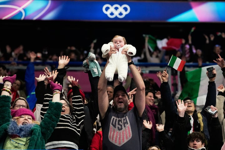 Fans applaud before the figure skating ice dance team event.