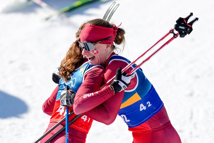 Switzerland's Nadine Faehndrich celebrates with teammate Nadja Kaelin after winning the silver medal in the women's cross-country skiing team free sprint.