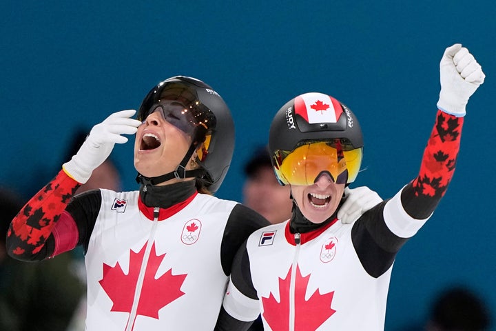 Canada's Valerie Maltais (left) and Ivanie Blondin celebrate winning gold in the women's team pursuit speed skating race.