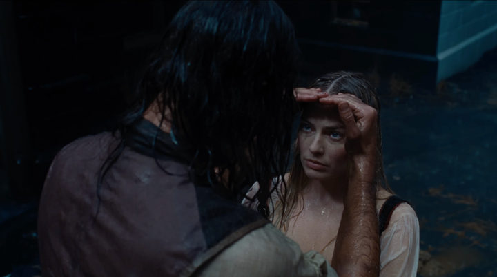 Heathcliff shields Cathy's eyes from the rain in Wuthering Heights, in a moment that was actually improvised by Jacob Elordi