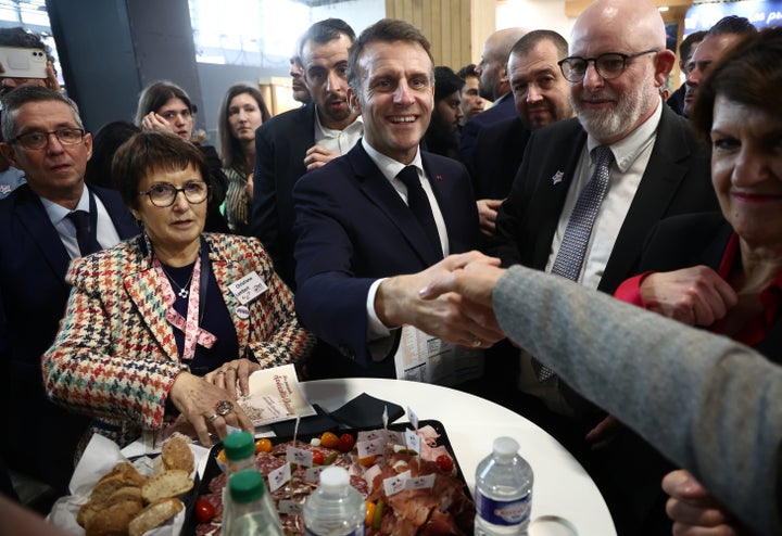 French President Emmanuel Macron, center, with Christiane Lambert, left, at the International Agriculture Fair during the opening day in Paris, Saturday, Feb. 21, 2026. (Christophe Petit Tesson/Pool Photo via AP)