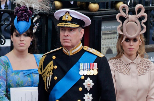 Former Prince Andrew, center, and his daughters Princess Eugenie, left, and Princess Beatrice leave Westminster Abbey after the wedding of Prince William to Catherine Middleton, in London, April 29, 2011. 
