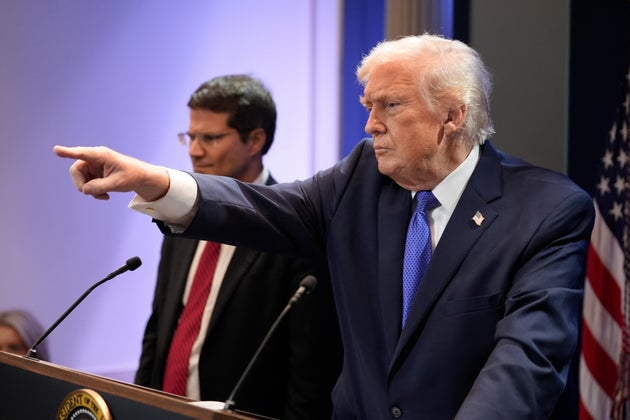 President Donald Trump, right, joined by Solicitor General John Sauer, as Trump speaks with reporters in the James Brady Press Briefing Room at the White House, Friday, Feb. 20, 2026, in Washington.