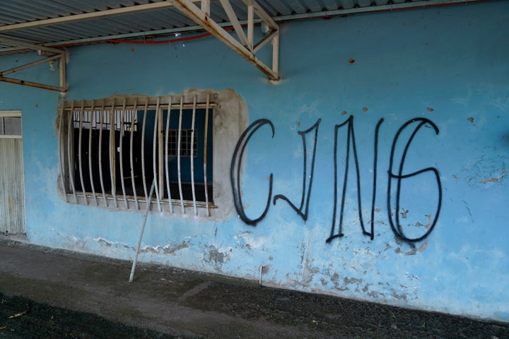 FILE - The letters "CJNG" for the group's formal name, Jalisco New Generation Cartel, covers the facade of an abandoned home in El Limoncito, in the Michoacan state of Mexico, Oct. 30, 2021. (AP Photo/Eduardo Verdugo, File)