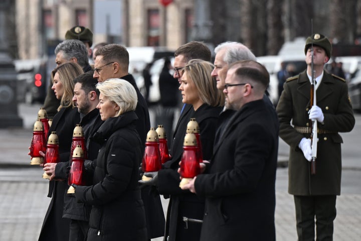 Ukrainian President Volodymyr Zelensky along with First Lady Olena Zelenska and foreign leaders place candles during the ceremony to mark the fourth anniversary of the large-scale Russian invasion of Ukraine at Independence Square on February 24, 2026 in kyiv, Ukraine.