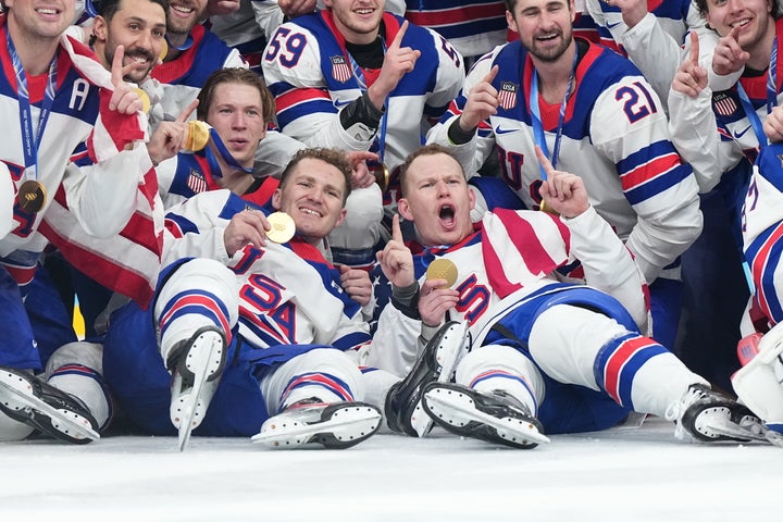 The US men's hockey team poses with gold medals after winning the gold medal on Sunday.