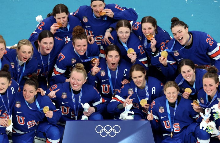 The United States women's hockey team poses with their gold medals after winning last week in Milan.