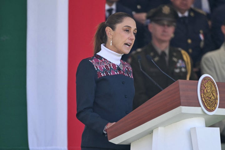 Mexico's President Claudia Sheinbaum delivers a speech during the celebration of Flag Day in Mexico City on Feb. 24, 2026. Sheinbaum offered "full guarantees" for the safety of football fans at World Cup games in the violence-plagued city of Guadalajara. Sheinbaum has said she is considering legal action following a comment by tech billionaire Elon Musk, the world's richest man, that alleged she was connected to drug cartels.