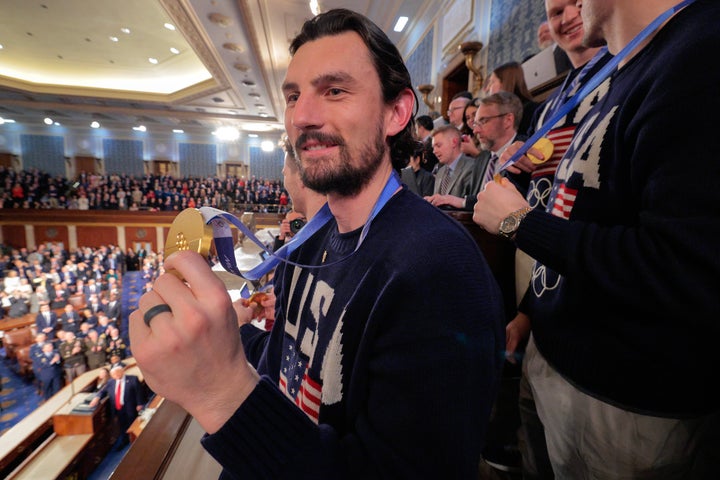 Members of the Team USA Men's Hockey Team, including goalie Connor Hellebuyck, wave to the audience as President Donald Trump delivers his State of the Union address.