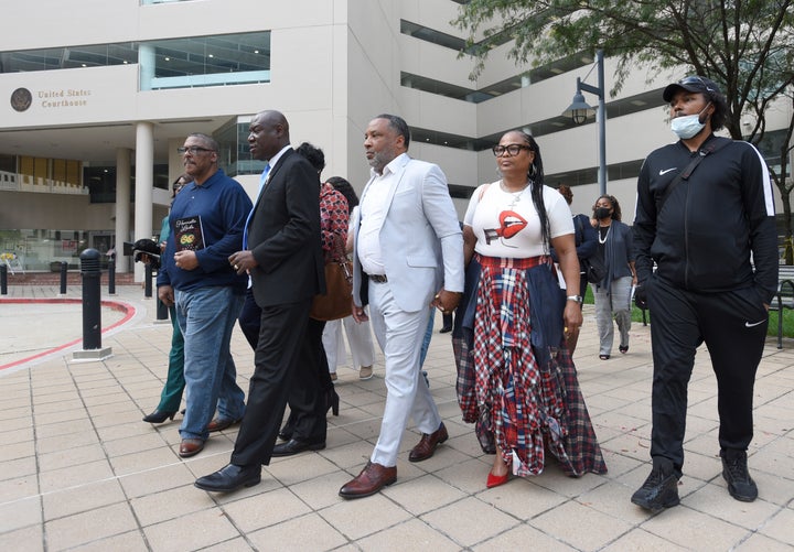 Attorney Ben Crump, second from left, walks with Ron Lacks, left, Alfred Lacks Carter, third from left, both grandsons of Henrietta Lacks, and other descendants of Lacks, outside the federal courthouse in Baltimore in 2021. Novartis settled a lawsuit with the Lacks estate this month that alleged the pharmaceutical giant unjustly profited off her cells.