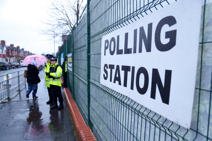 Voters in the Longsight area of Manchester, northwest England, enter a polling station, Thursday Feb. 26, 2026, as voters head to the polls in the Gorton and Denton constituency. (AP Photo/Jon Super)