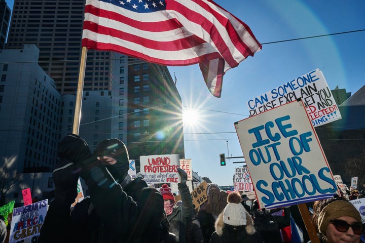 A demonstrator holds an "ICE Out of Our Schools" sign during a nationwide strike in Minneapolis on Jan. 30, 2026.