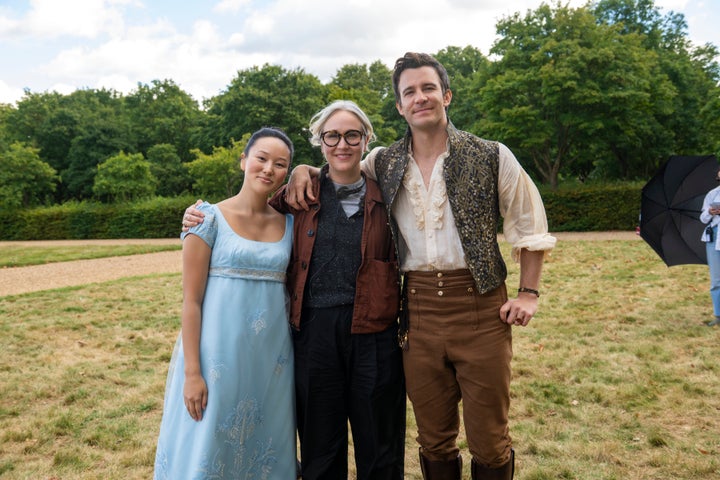 Yerin Ha and Luke Thompson on the set of Bridgerton with showrunner Jess Brownell