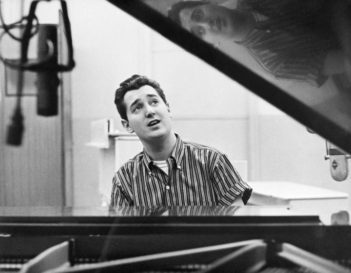 Singer Neil Sedaka sitting at the piano.
