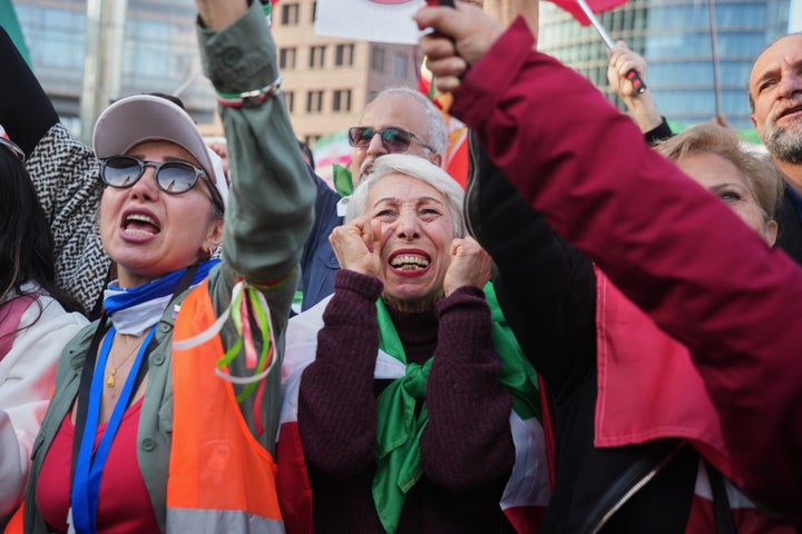 Iranian people attend a demonstration in support of the U.S. and Israeli strikes on Iran, in Berlin, Germany, Saturday, Feb. 28, 2026. (AP Photo/Markus Schreiber)