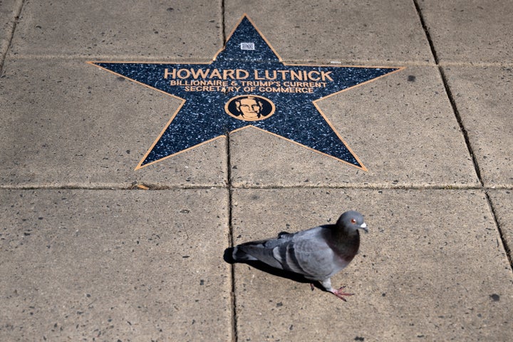A bird walks past a star with the name of Commerce Secretary Howard Lutnick on the "Jeffrey Epstein Walk of Shame," a pop-up display that appeared near the White House on Sunday. Lutnick admitted to having lunch on Epstein's private island in 2012, but strenuously denied any closer relationship with the convicted sex offender.