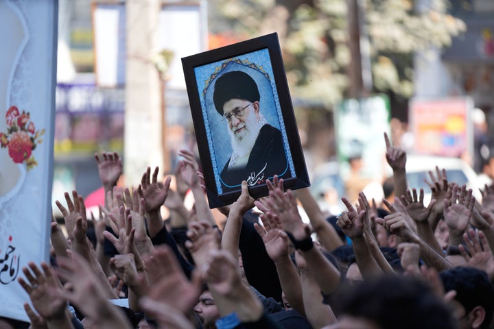 Shiite Muslims hold an image of Iran's Supreme Leader Ayatollah Ali Khamenei during a protest against the U.S. and Israel in Jammu, India, Sunday, March 1, 2026.(AP Photo/Channi Anand)
