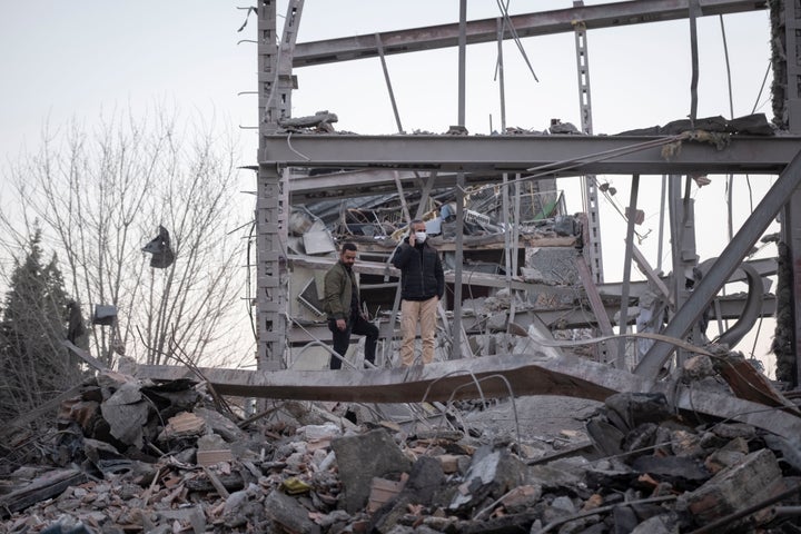 Two men stand on the ruins of a police headquarters that was destroyed in the U.S.-Israeli attack on Tehran, Iran, on March 2, 2026.
