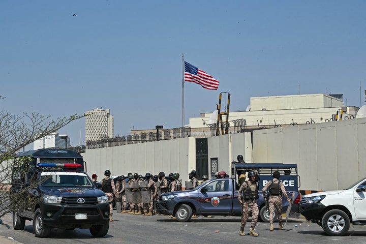 Security personnel stand guard outside the U.S. consulate in Karachi on March 1, 2026 during a clash with Shiite Muslims as they attempt to storm the premises after the death of Iran's supreme leader Ayatollah Ali Khamenei amid U.S.-Israel strikes.