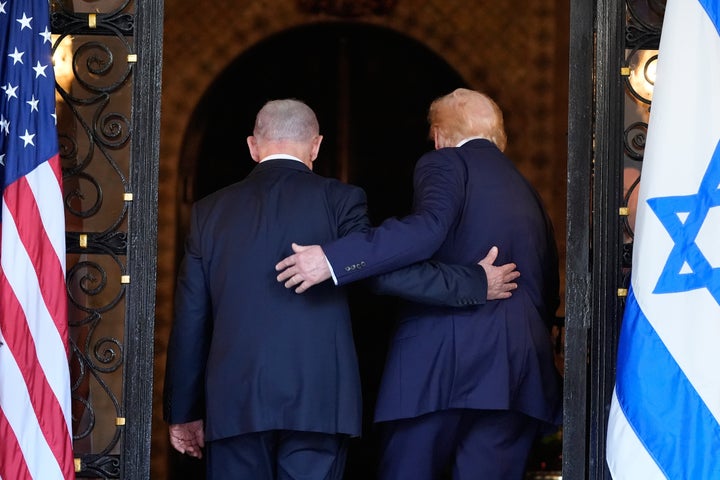President Donald Trump and Israel's Prime Minister Benjamin Netanyahu walk into Trump's Mar-a-Lago club, Monday, Dec. 29, 2025, in Palm Beach, Fla., after an arrival greeting.
