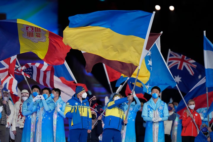 Vitalii Lukianenko carries the flag of Ukraine during the closing ceremony at the 2022 Winter Paralympics, Sunday, March 13, 2022, in Beijing. (AP Photo/Shuji Kajiyama)