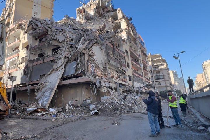 Workers gather in front of a destroyed building that was hit by an Israeli airstrike in Dahiyeh, Beirut's southern suburbs, Lebanon, on March 5, 2026.