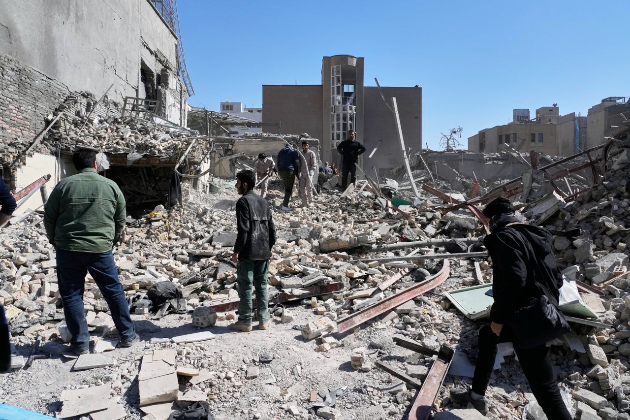 A group of men inspects the ruins of a police station struck Monday amid the US–Israeli military campaign in Tehran, Iran, Tuesday, March 3, 2026. 