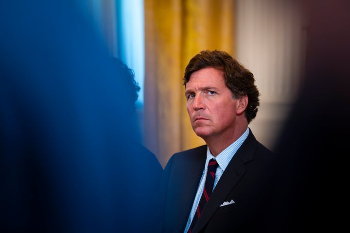 Tucker Carlson, pictured at the White House on Jan. 9, told Status reporter Oliver Darcy he'll "always love" Donald Trump, despite clashing with the president over the war in Iran.