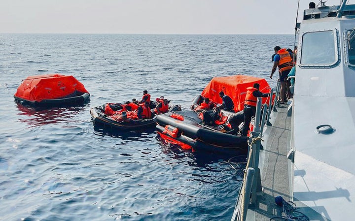 In this photo released by Sri Lankan President Media Division, Sri Lankan Navy sailors rescue Iranian sailors after the Dena warship sank outside Sri Lanka's territorial waters on Wednesday.