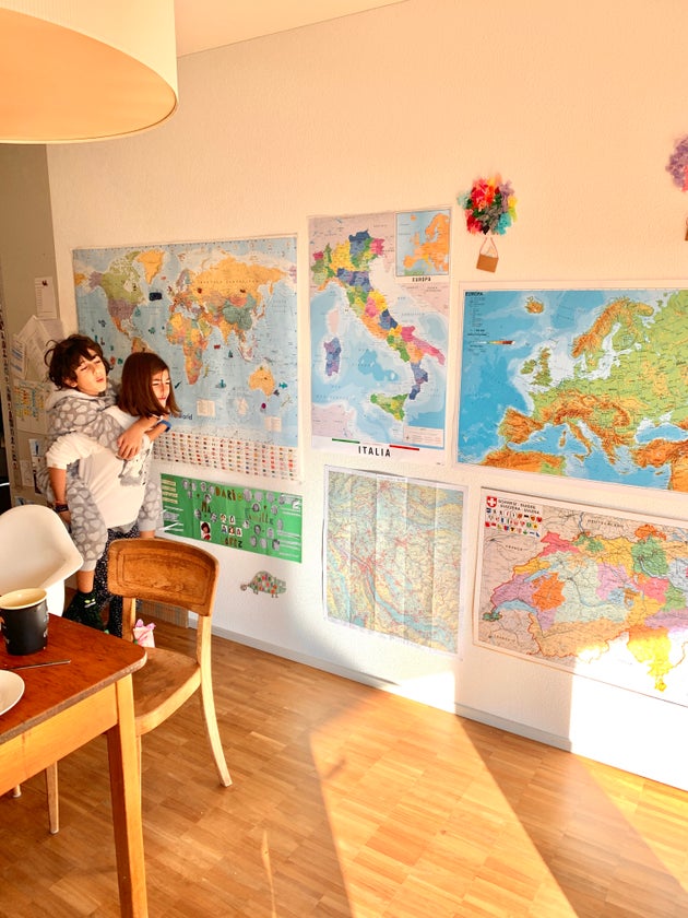 The author's kids playing in front of a wall of maps