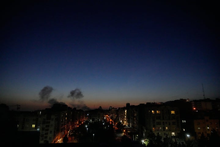 Plumes of smoke rise as strikes hit the city during the U.S.–Israeli military campaign in Tehran, Iran, Friday, March 6, 2026. (AP Photo/Vahid Salemi)