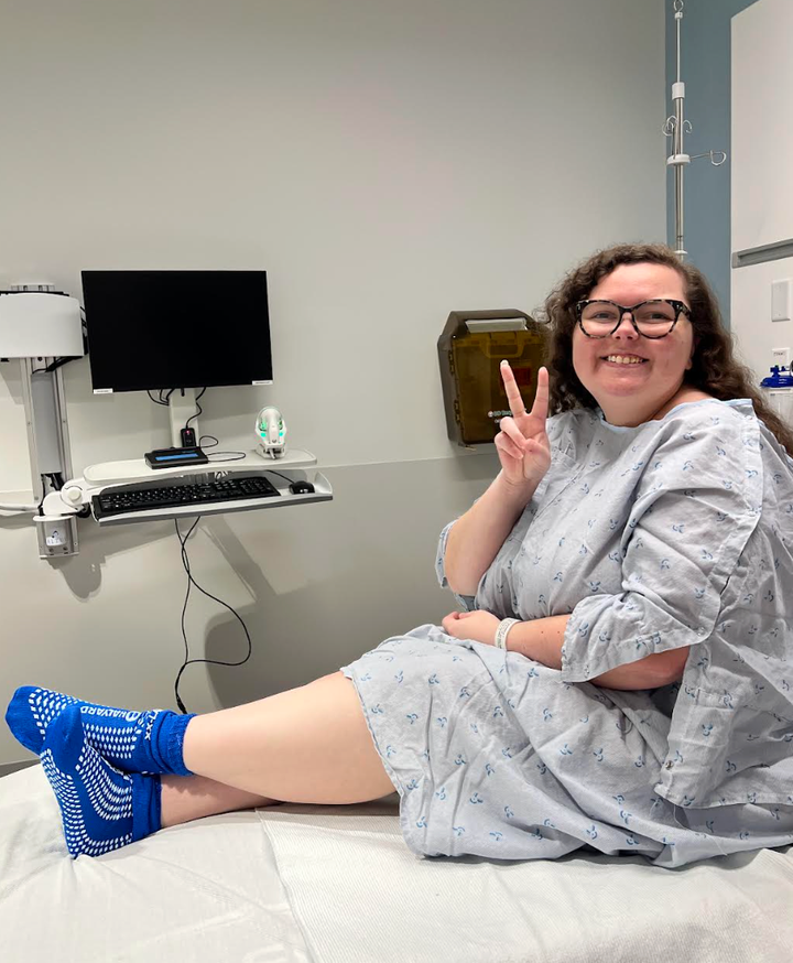 The author in the pre-op room, all gowned up. "I wouldn’t put on the hair net that looked like it was made of tin foil until they made me," she writes.