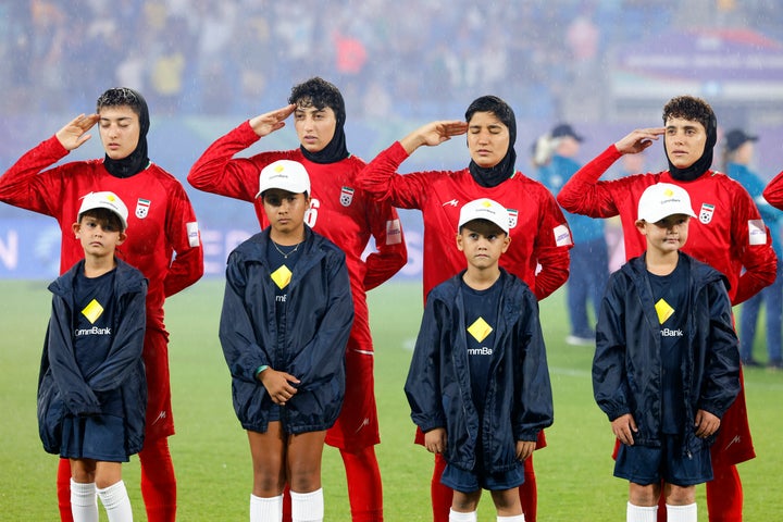 Iran's players salute during the national anthem before the AFC Women's Asian Cup Australia 2026 football match between Iran and Philippines in Gold Coast on March 8, 2026. The son of the late shah urged Canberra on March 9 to protect the Iranian women's football team, who were branded "wartime traitors" after refusing to sing the national anthem while playing in Australia. 