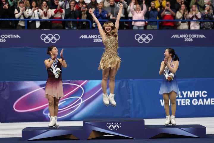 Liu celebrates on the podium during the women's singles skating medal ceremony on February 19.