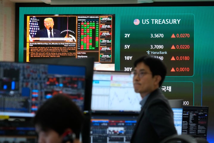 U.S. President Donald Trump is seen on a screen as traders work at the foreign exchange dealing room of the Hana Bank headquarters in Seoul, South Korea, on March 10, 2026.
