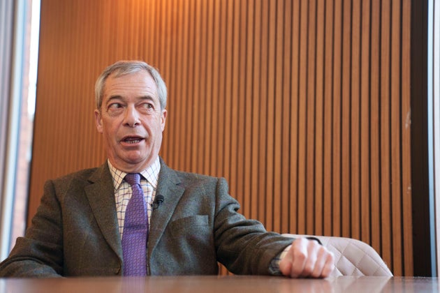 Reform leader Nigel Farage sits in a cafe during a campaign visit to Gorton and Denton in Manchester, England, Friday, Jan. 30, 2026.