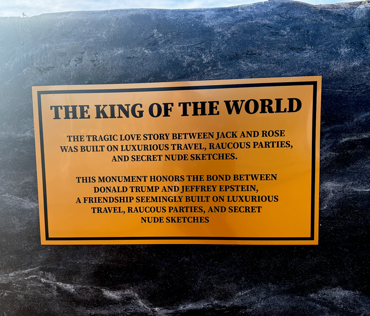 A placard at the base of the statue compares Trump and Epstein to Jack and Rose in “Titanic.”